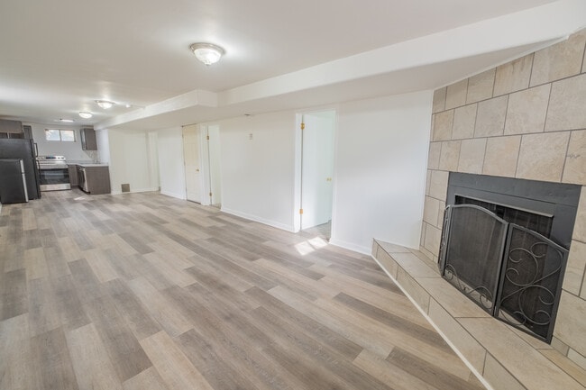 Large open concept living room/kitchen area. Fireplace is not functional. - 1415 Concord St Unit 2