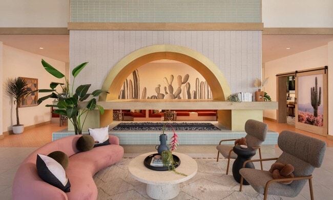 A statement lobby with desert tones, layered lighting, and inviting seating—welcome home to Modera Rio Salado.
