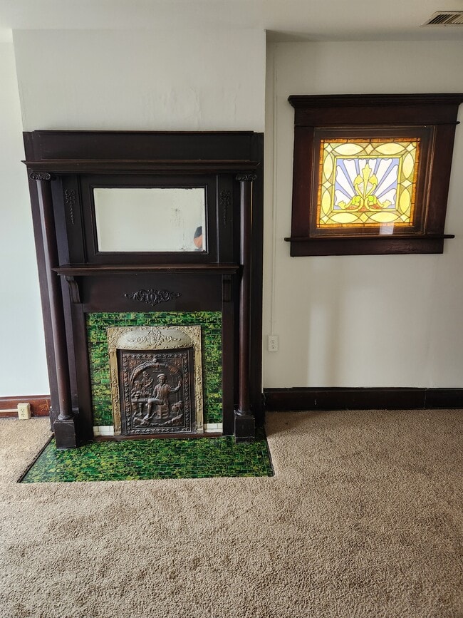 Original fireplace (non working) and stained glass window, original fireplace tile