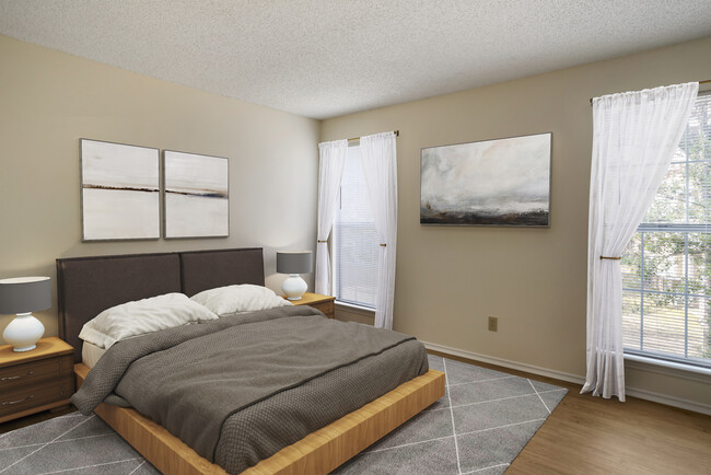 Renovated Package I bedroom featuring hard surface flooring in select units