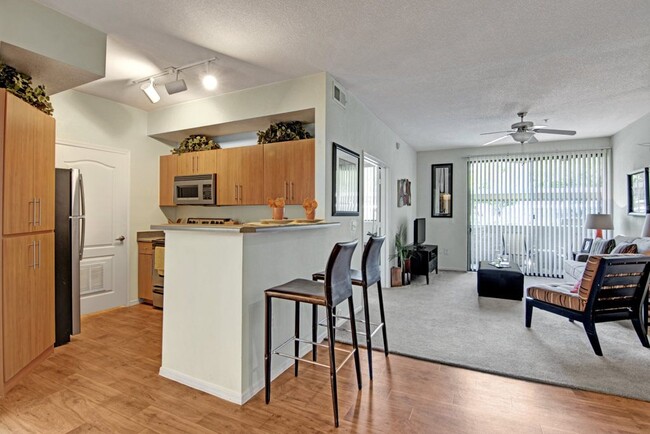 Acclaim Apartments- furnished kitchen with wooden floors - Acclaim