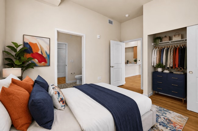 Spacious primary bedroom with a spacious closet and modern finishes at 27 West Apartments.