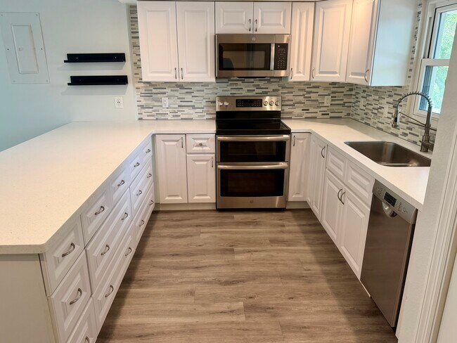 Renovated kitchen with breakfast bar - 105 4th Ave NE Unit 206