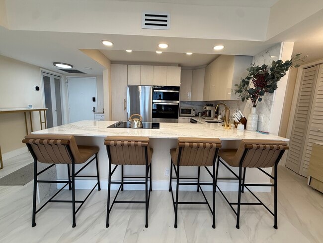 Kitchen Island with pop-up electrical outlets - 500 Three Islands Blvd Unit 214A