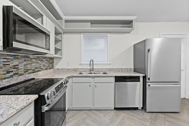 Building Photo - Updated Two-Bedroom Condo with New Kitchen Appliances and Private Patio