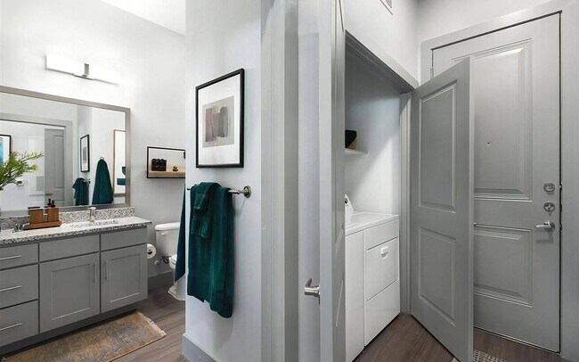 Laundry at home sits in its own closet right beside the front door.