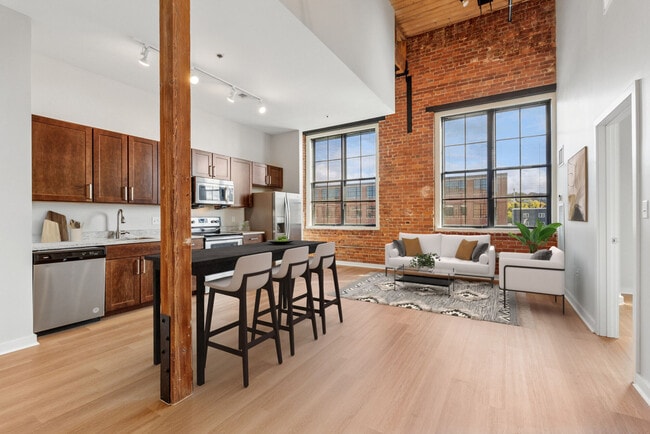Open-concept loft apartment with high ceilings, oversized windows, and contemporary finishes
