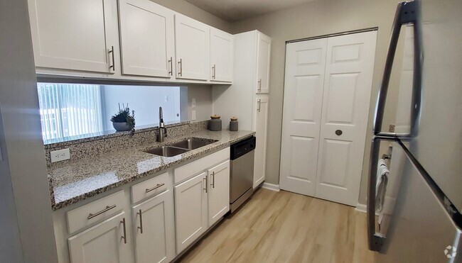 Renovated kitchen with stainless steel appliances and granite countertops - Summerfield Apartments