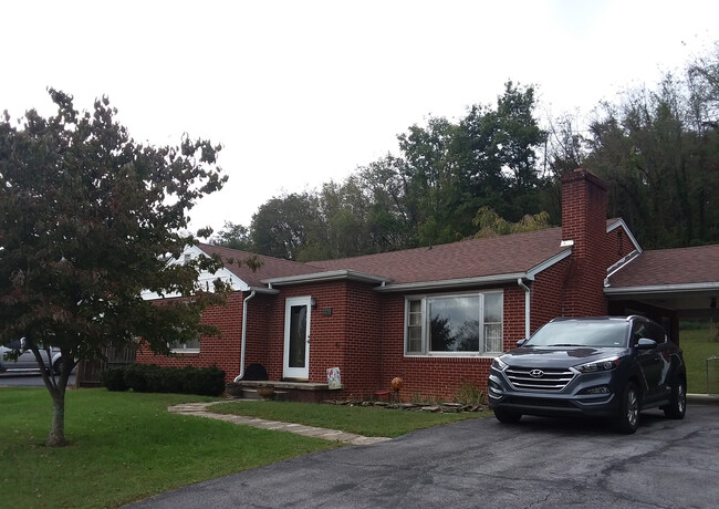 Driveway has covered carport and room for two more cars. - 1255 Culbert Dr House