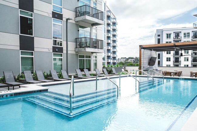 Resort-inspired heated pool with lounge areas
