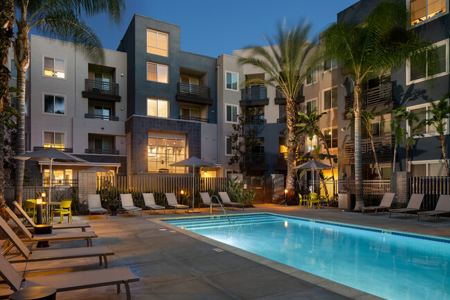 Swimming pool and sundeck at dusk - Avalon Warner Place Apartments