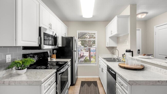 Our beautifully remodeled, chef-inspired kitchens adorned with opulent marble-like countertops and stainless-steel appliances.
