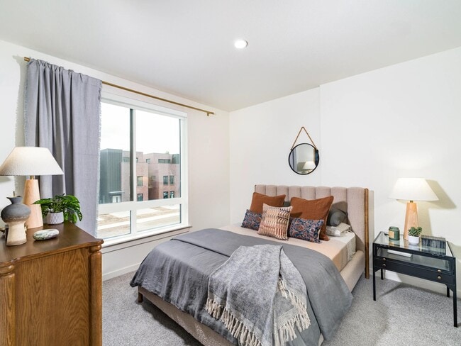 A serene bedroom retreat at Modera University Park, pairing soft finishes and natural light with a location close to University Park’s dining and culture.