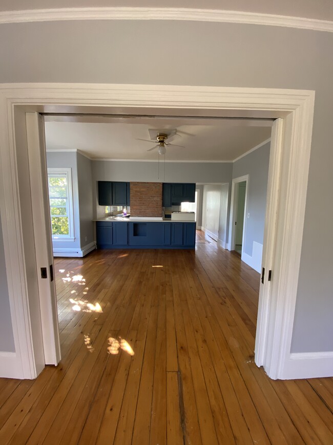 Dining room/second parlor with view of open concept kitchen - 86 Holden St Apartments Unit 2