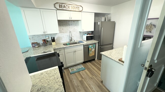 Fully equipped kitchen. Keurig coffee maker and all new stainless steel appliances - 2800 N Atlantic Ave Condo Unit 108