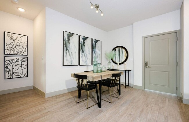 Elevate your living with modern design and a touch of elegance at The Edison Daytona Apartments. This inviting dining area features sleek furnishings and ample natural light, perfect for gatherings. Schedule your tour today!
