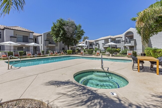 Dive into relaxation in our pool oasis with a hot tub and shaded lounging area