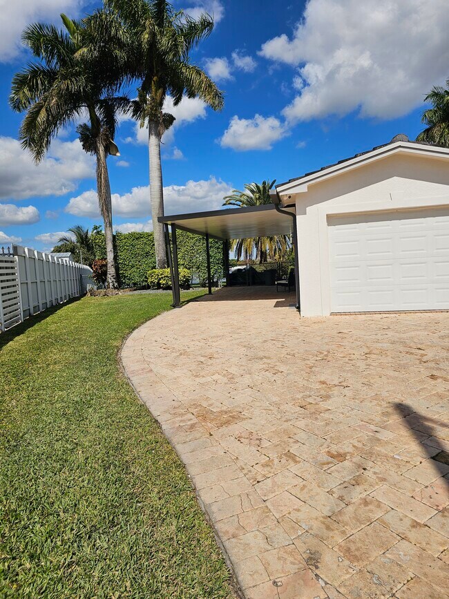 Side entrance, aluminum carport with lighting - 17451 NW 52nd Pl