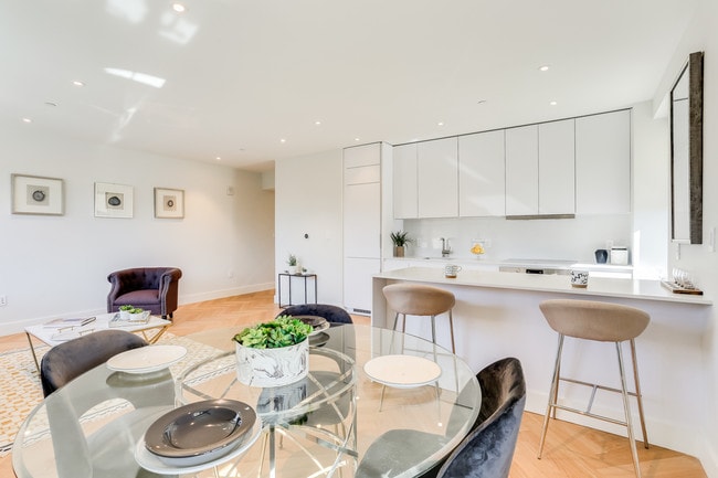 Open concept, newly renovated kitchen with Quartz countertops and an integrated fridge and dishwasher