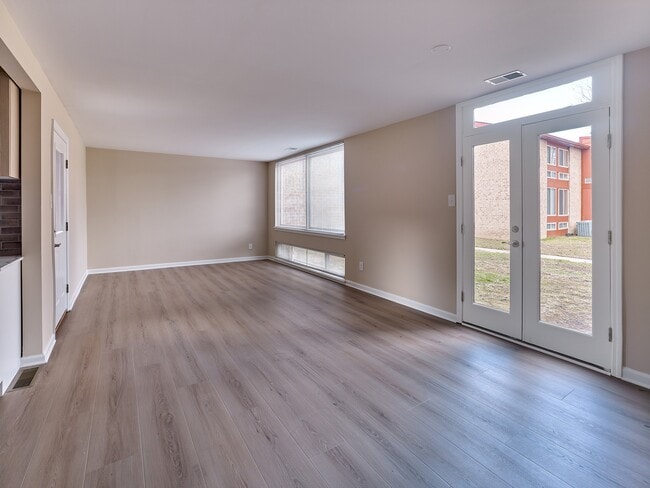 Spacious 2 Bed, 1.5 Bath with 989 sq. ft., large windows, and beautiful wood-style flooring.