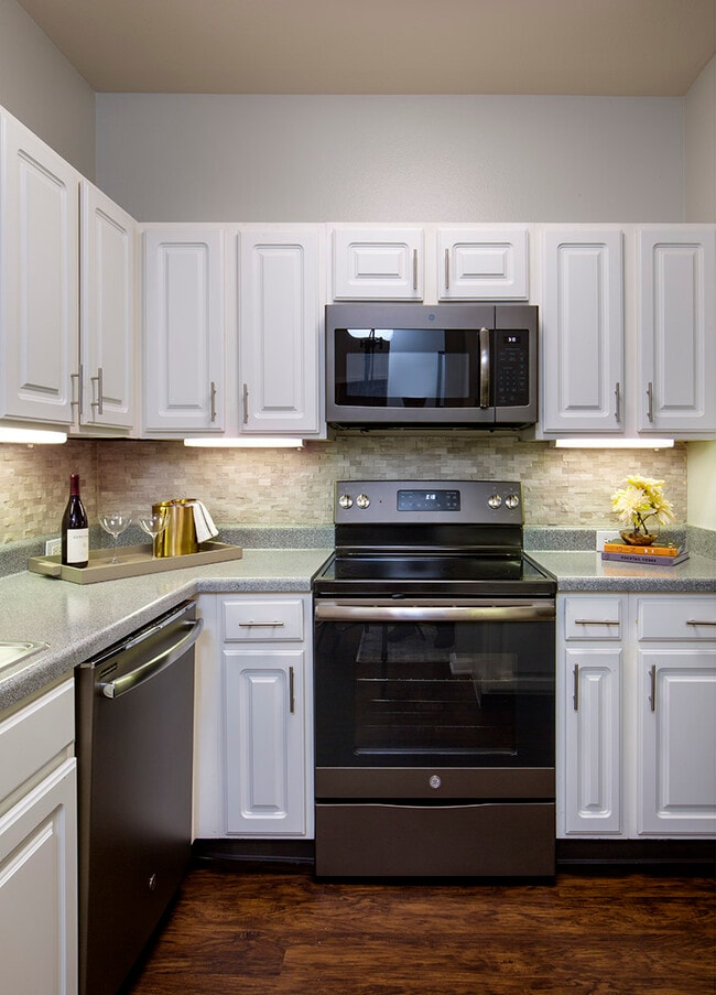 Kitchen with Slate Appliances and White Cabinetry