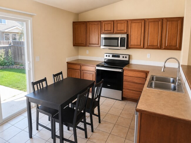 Photo - Bright Open-Concept Home with Fenced Yard, Double Garage & Community Amenities