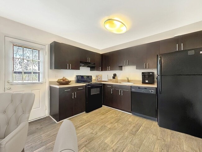 Kitchen with Espresso Cabinets - Forest Hills Apartments