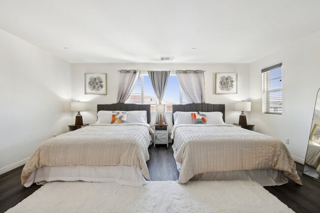 This spacious bedroom with two queen-size beds is perfect for a restful getaway. - 28754 Lookout Cir