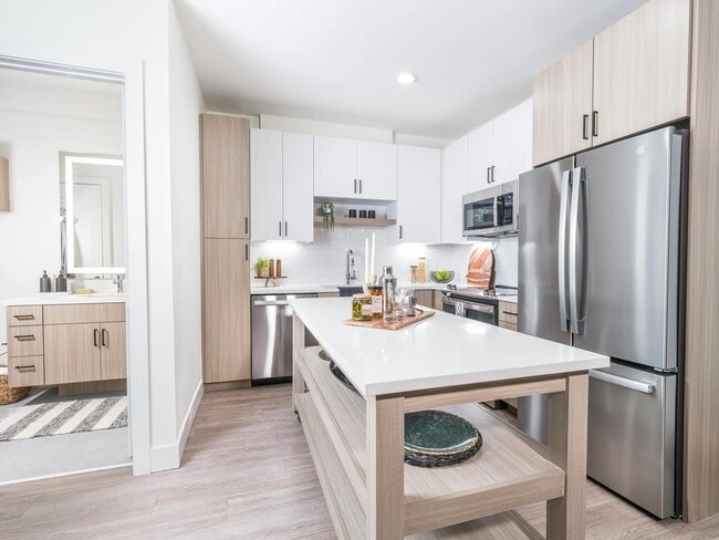 Creating culinary magic with a chef's dream island complete with ample storage, found in the heart of Modera Golden Triangle, Denver, Colorado. - Modera Golden Triangle Apartments