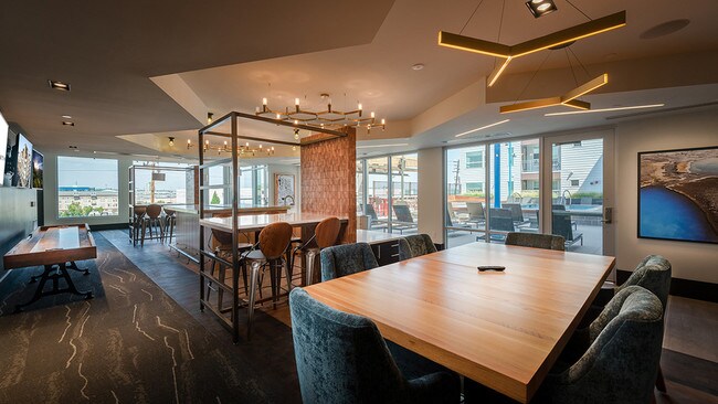 Club house with shuffleboard and ample social seating options - Modera River North