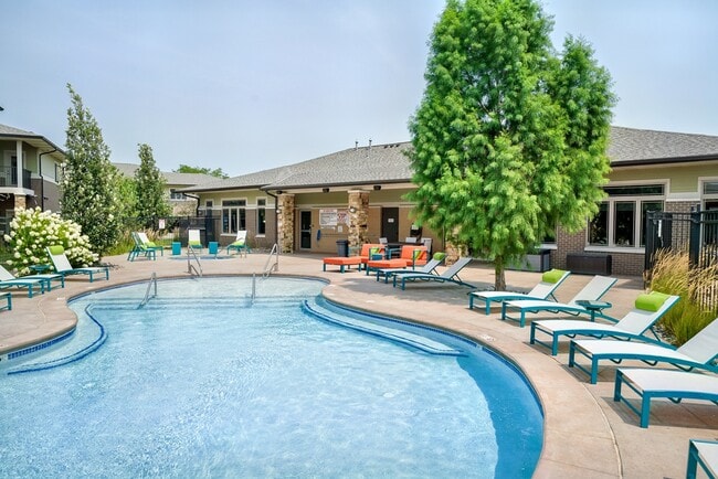Our resort-style pool with lounge seating is the perfect place for relaxation. - The Villas at Wilderness Ridge Rental