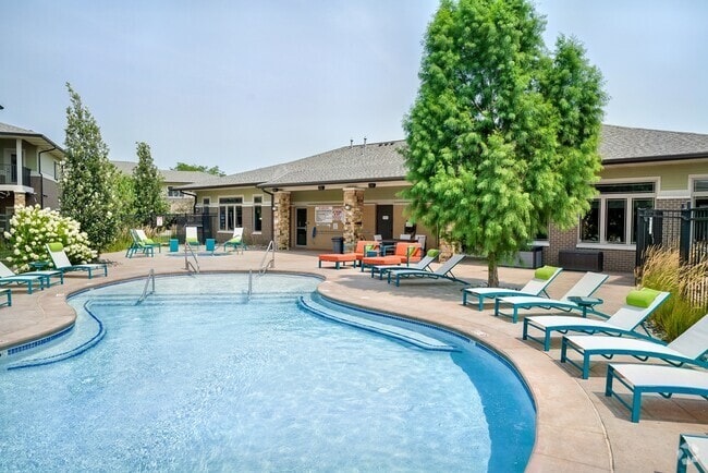 Our resort-style pool with lounge seating is the perfect place for relaxation. - The Villas at Wilderness Ridge Rental
