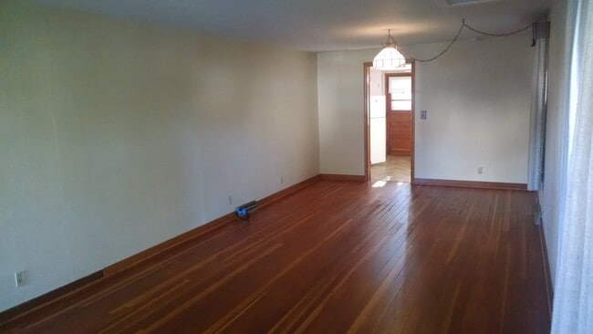 Living room looking into kitchen and back entry