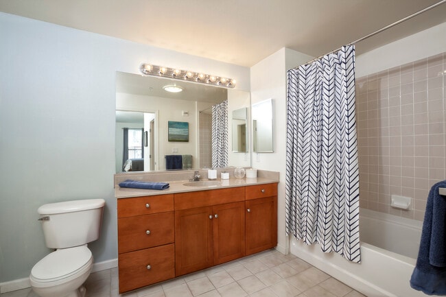 Classic Package I bath with cherry cabinetry, laminate countertops, and tile flooring