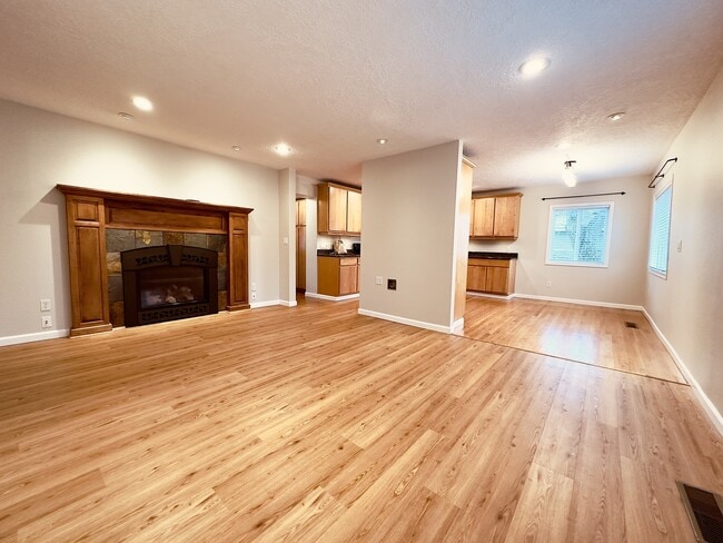 View of living room, dining room, and kitchen - 8717 NE Webster St House Unit A