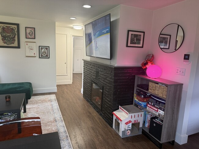Living room with electric fireplace - 814 N 105th St Unit Greenwood duplex