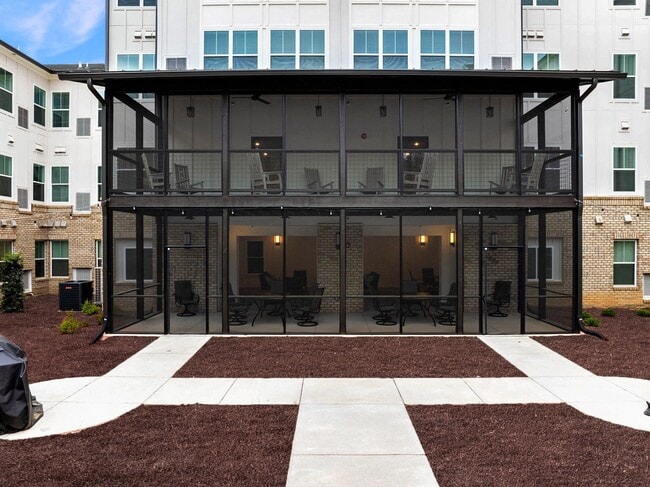 Active Adult Apartments with a covered deck with rocking chairs - The Lawson of Knightdale