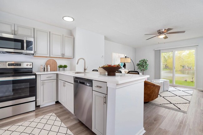 Premium Trentwood kitchen with grey cabinetry, granite countertops, and stainless-steel appliances.