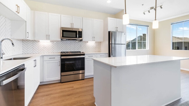 Kitchen with Quartz Countertops and Stainless Steel Appliances - Promenade at Town Center