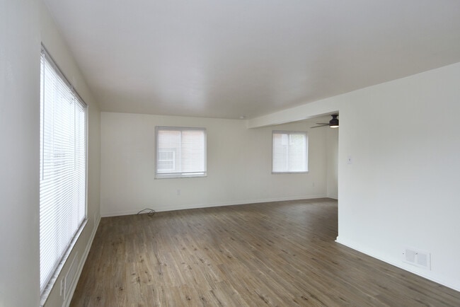 Freshly painted spacious living room with all-new luxury vinyl plank flooring and mini-blinds throug - 3156 Glendale Ave Unit 1