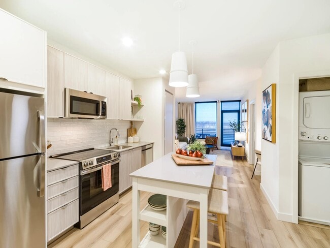 An open kitchen with refined finishes, in-home laundry, and a seamless flow into your living space.