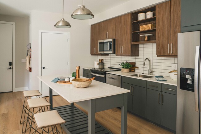 Experience culinary elegance at Modera Germantown with sleek quartz countertops and contemporary design. - Modera Germantown Apartments