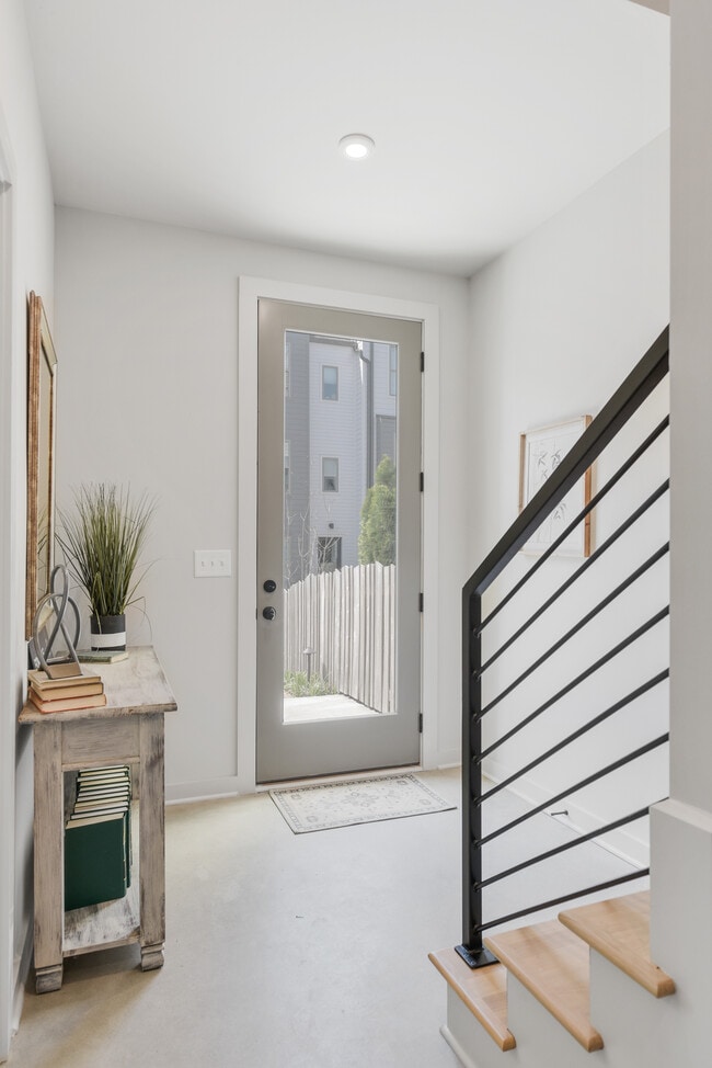 Bright and welcoming entryway with sleek finishes and modern rail detail. - 358 E Village Ln Rental
