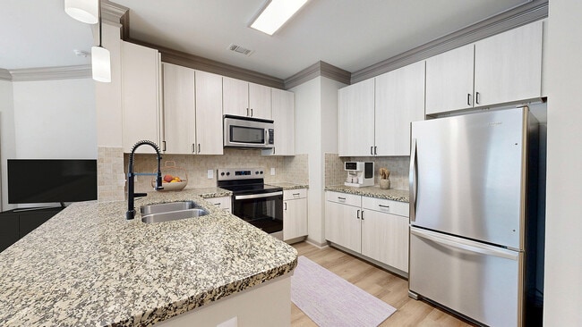 Newly Renovated Kitchen with Granite Countertops - Avenues at Craig Ranch Apartments