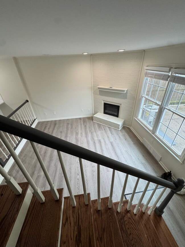 view from stairs into living room with fireplace