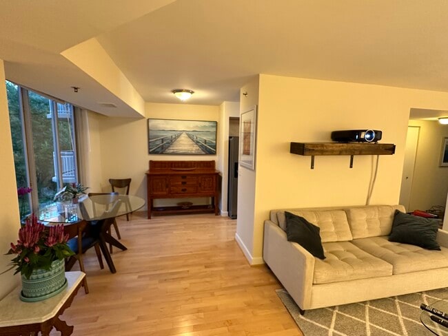 dining area and partial view of living room - 7500 Woodmont Ave Unit 407