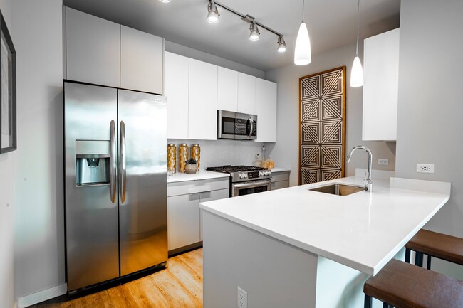 Unit Kitchen with Stainless Steel Appliances and Quartz Countertops at The Grand Central Apartments in Chicago, IL 60607 - The Grand Central Apartments