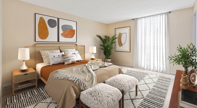 Elevate your living at Lakeshore Preserve with this beautifully designed bedroom featuring modern art and cozy furnishings. Enjoy a serene atmosphere and plenty of natural light. Schedule a tour today to find your perfect home. - Lakeshore Preserve