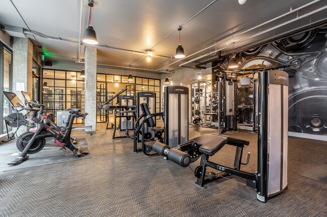 Community Gym with Weight Machines, Cardio Bikes, and Mirrors - Pike Motorworks