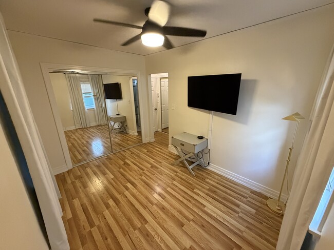 Bedroom with closet and mounted TV - optional - 815 14th St Unit 815 B Cottage